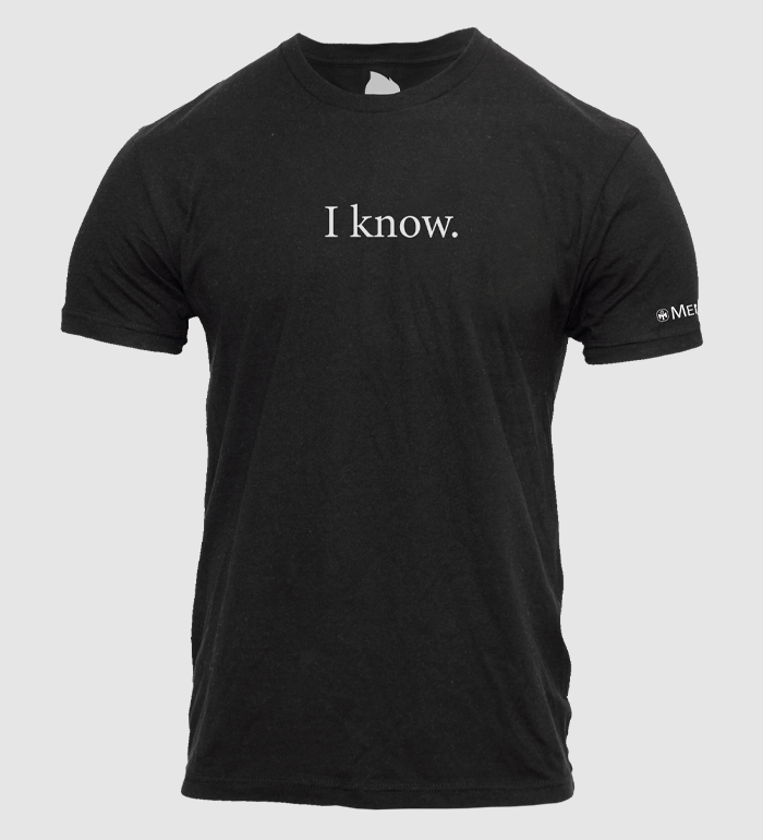 photo of black tee with "i know" text in white on front. mensa logo and text on left sleeve in white.