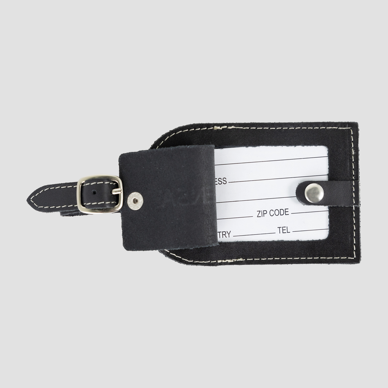 opened view of black leather luggage tag showing spaces to write contact info