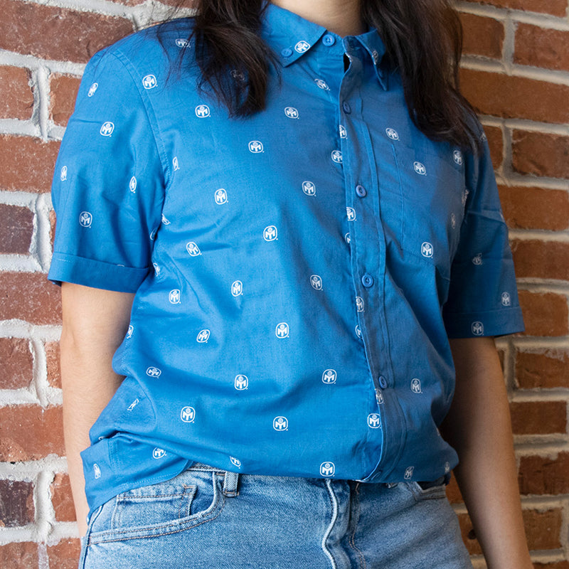 photo of female model wearing  blue buttondown with mensa logo pattern in white.